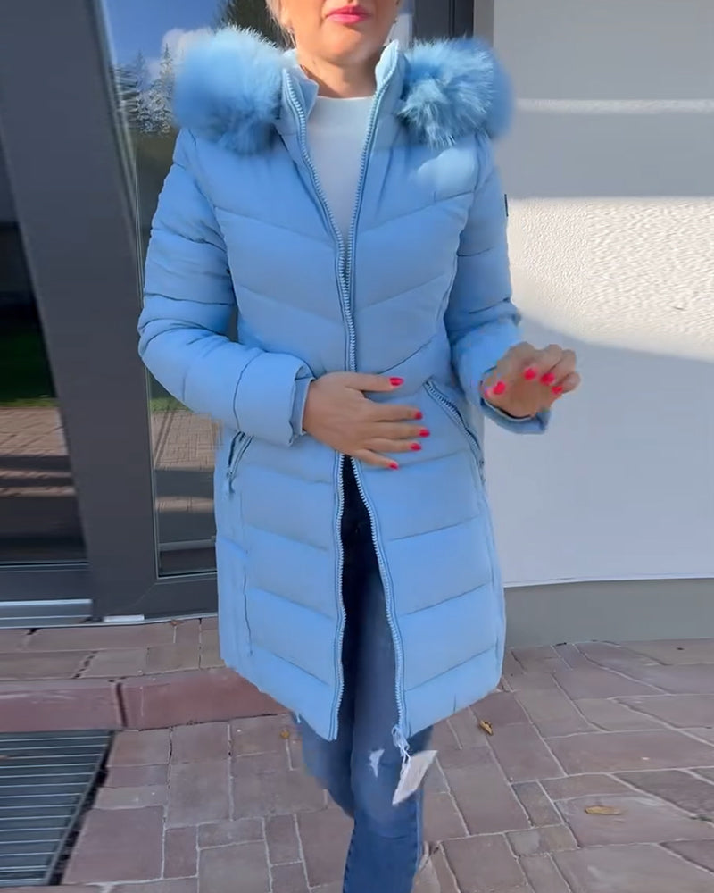 Women's blue quilted hooded coat with fluffy trim and zipped pockets
