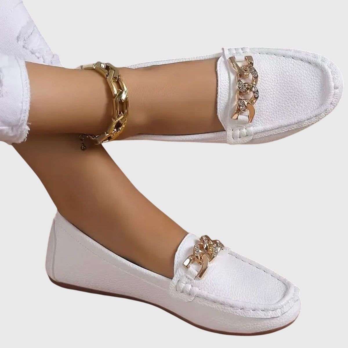 Women's flat slip-on loafers with moc toe stitching and decorative chain detail