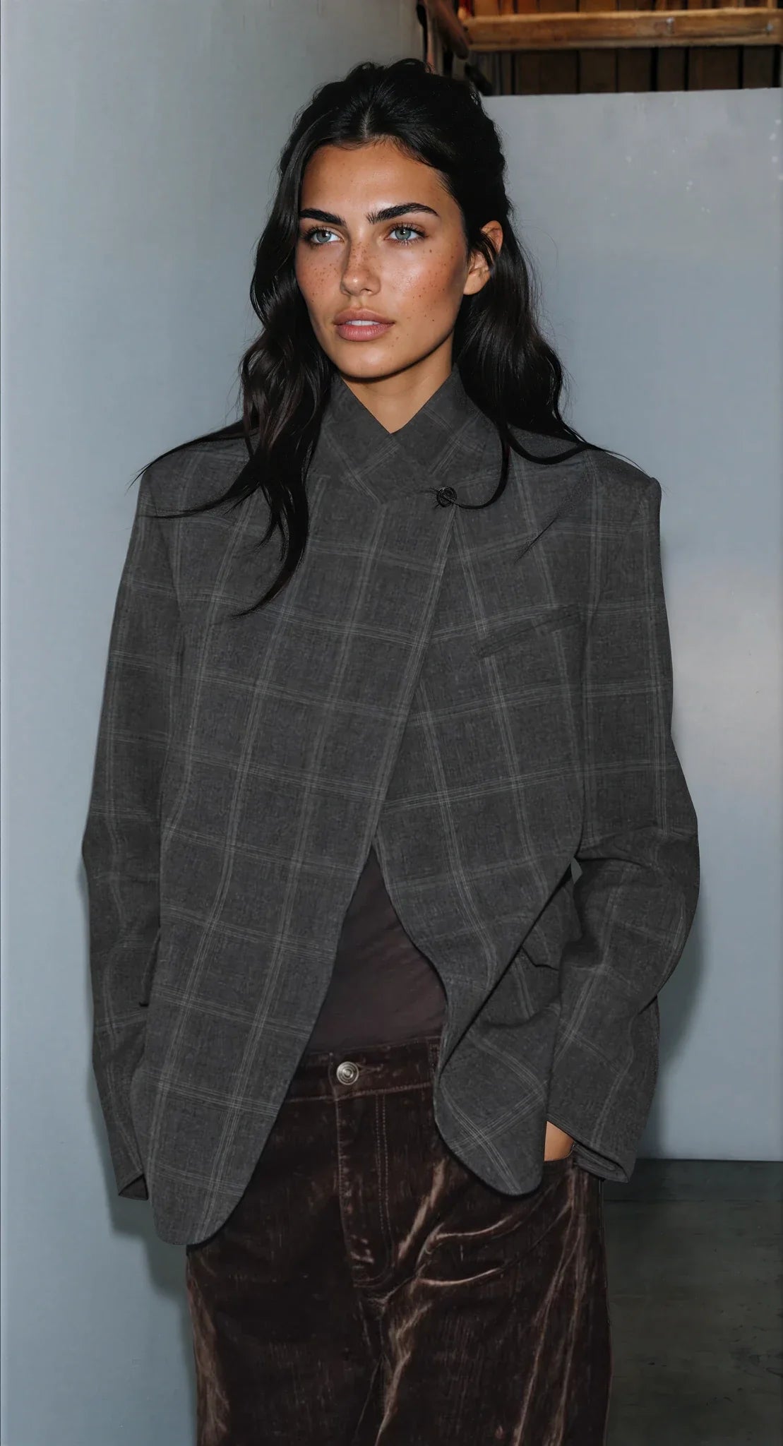 Women's dark checked blazer with high collar, long sleeves and flap pockets