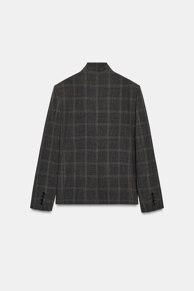 Women's dark checked blazer with high collar, long sleeves and flap pockets