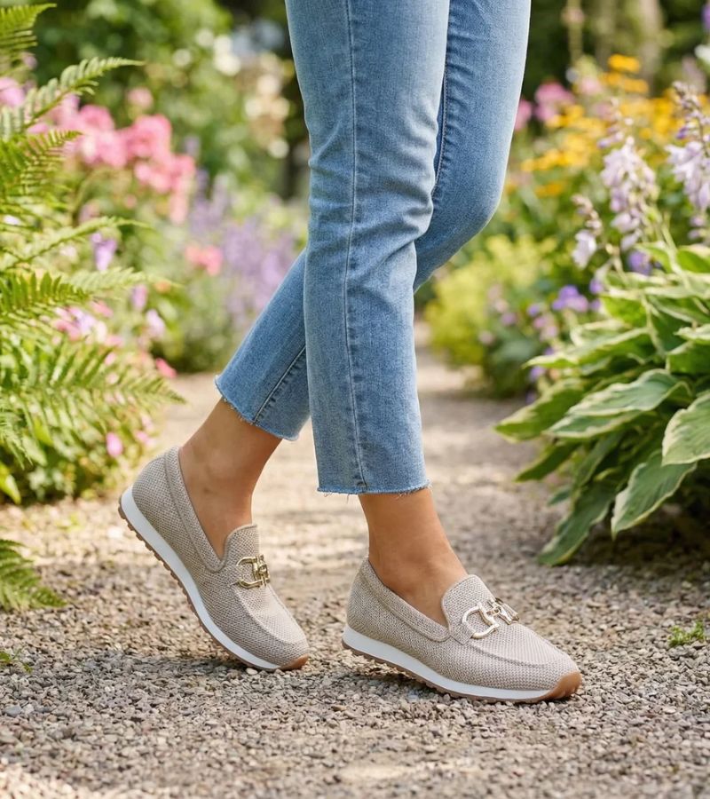 Women's textured slip-on loafers with decorative metal-tone buckles and ridged soles