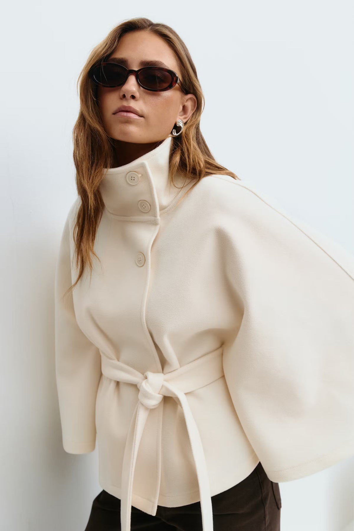 Women's cape coat with high collar, button front and tied waist belt