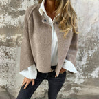 Women's cropped collarless jacket with long sleeves and button detail
