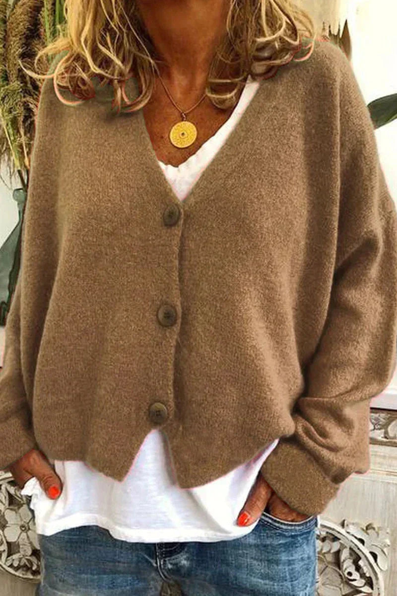 Women's long-sleeve V-neck button cardigan layered over a white top