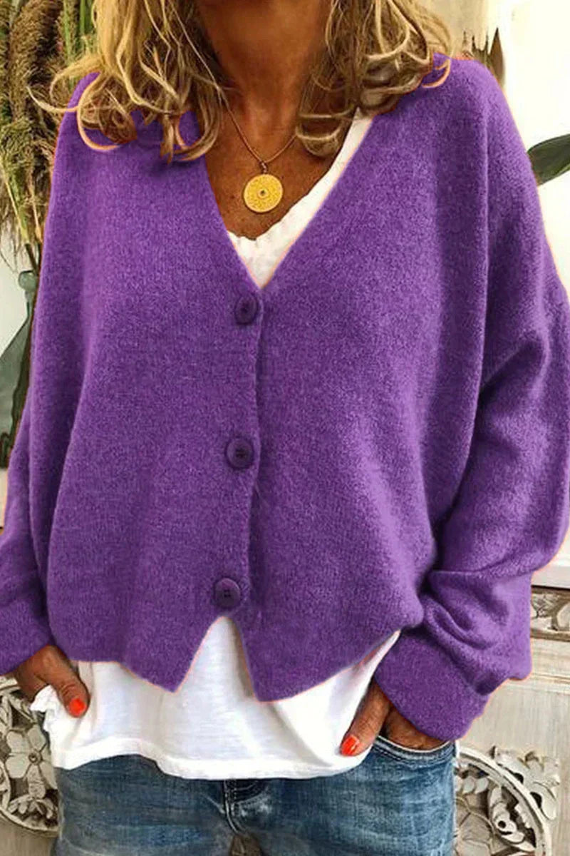 Women's long-sleeve V-neck button cardigan layered over a white top