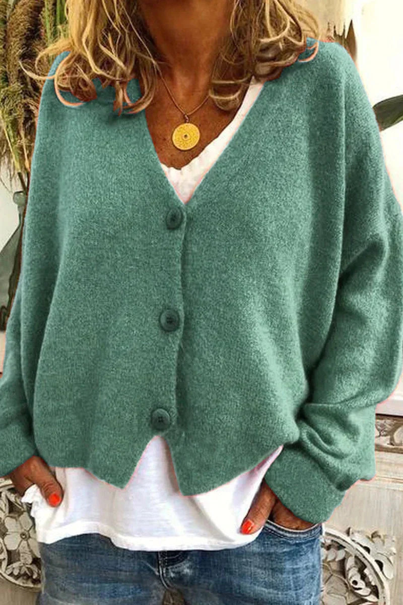 Women's long-sleeve V-neck button cardigan layered over a white top