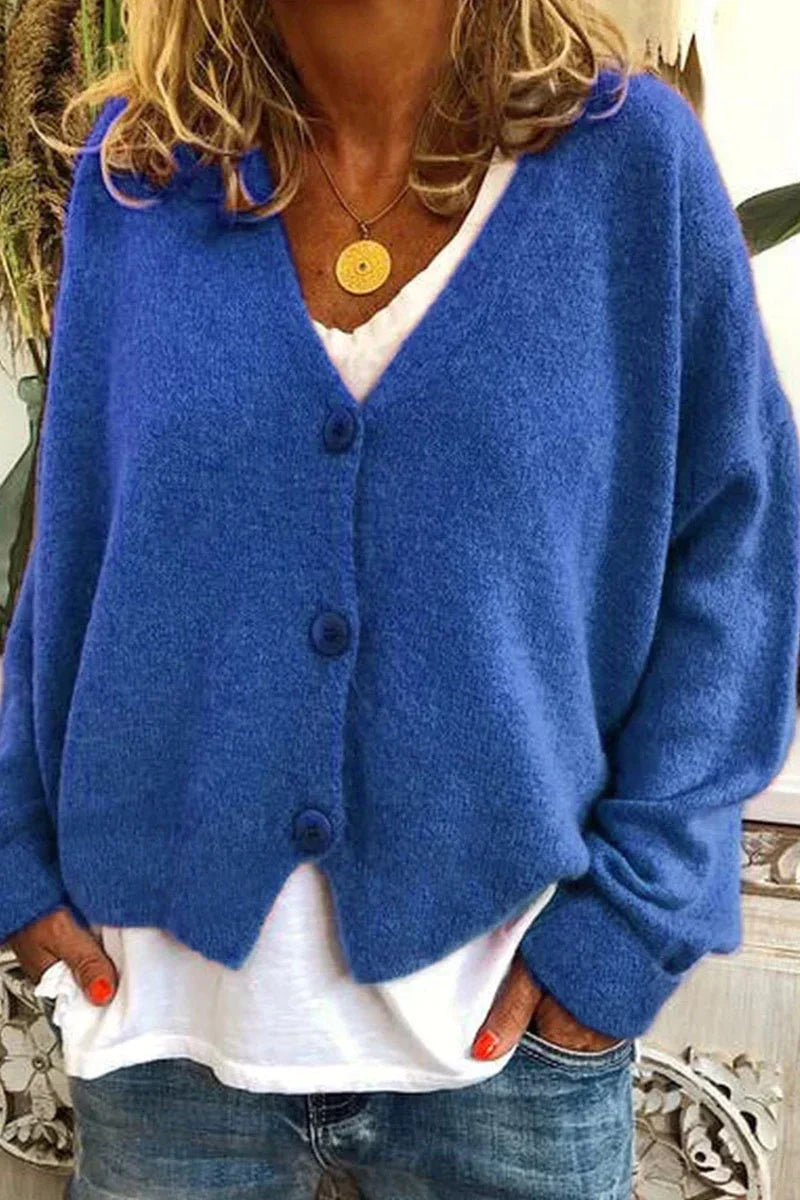 Women's long-sleeve V-neck button cardigan layered over a white top