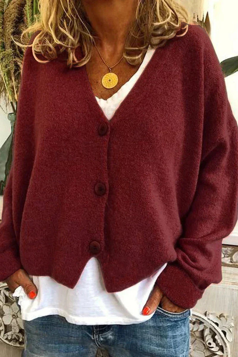 Women's long-sleeve V-neck button cardigan layered over a white top