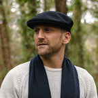 Black Kangol 504 flat cap with curved peak and embroidered logo