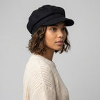 Black women's baker boy cap with rounded panelled crown and short curved brim