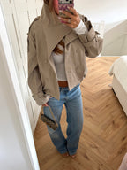 Women's beige cropped double-breasted trench jacket with long sleeves and adjustable cuffs