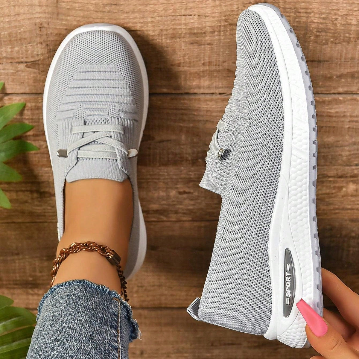 Women's light grey slip-on trainers with lace detail and white textured soles