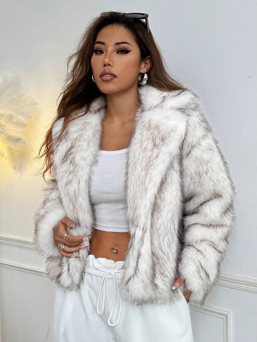Woman wearing an open-front faux fur jacket with wide lapels and long sleeves