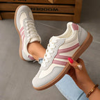 Women's low-top lace-up trainers with panelled side stripes and flat textured soles