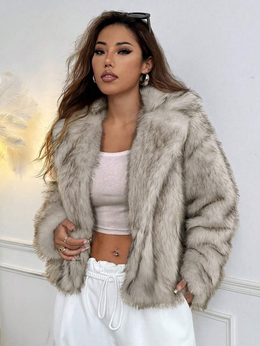 Woman wearing an open-front faux fur jacket with wide lapels and long sleeves