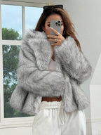 Woman wearing an open-front faux fur jacket with wide lapels and long sleeves