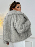 Woman wearing an open-front faux fur jacket with wide lapels and long sleeves