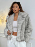 Woman wearing an open-front faux fur jacket with wide lapels and long sleeves