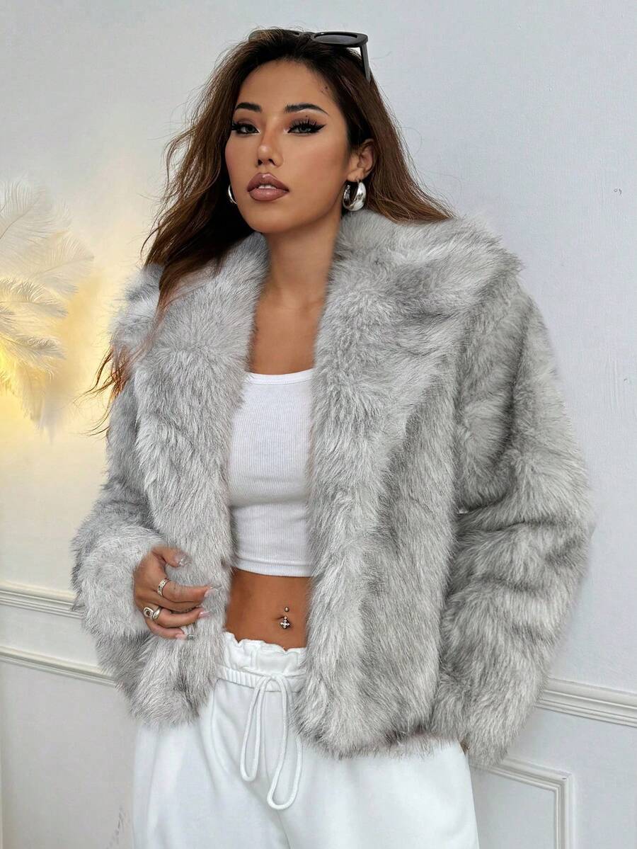 Woman wearing an open-front faux fur jacket with wide lapels and long sleeves