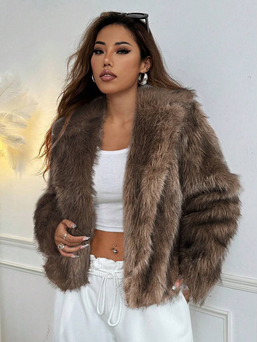 Woman wearing an open-front faux fur jacket with wide lapels and long sleeves