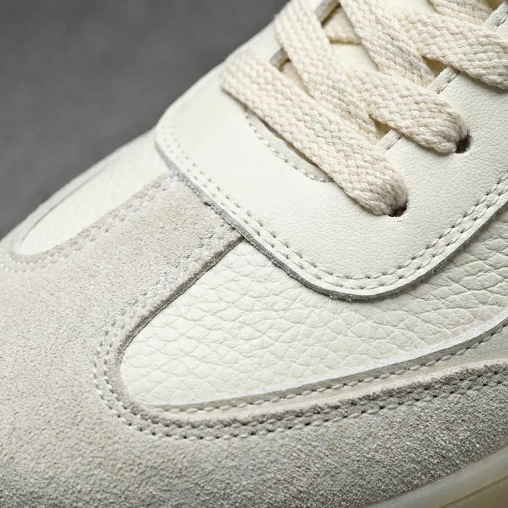 Beige men's lace-up sneakers with textured panels and gum-coloured soles
