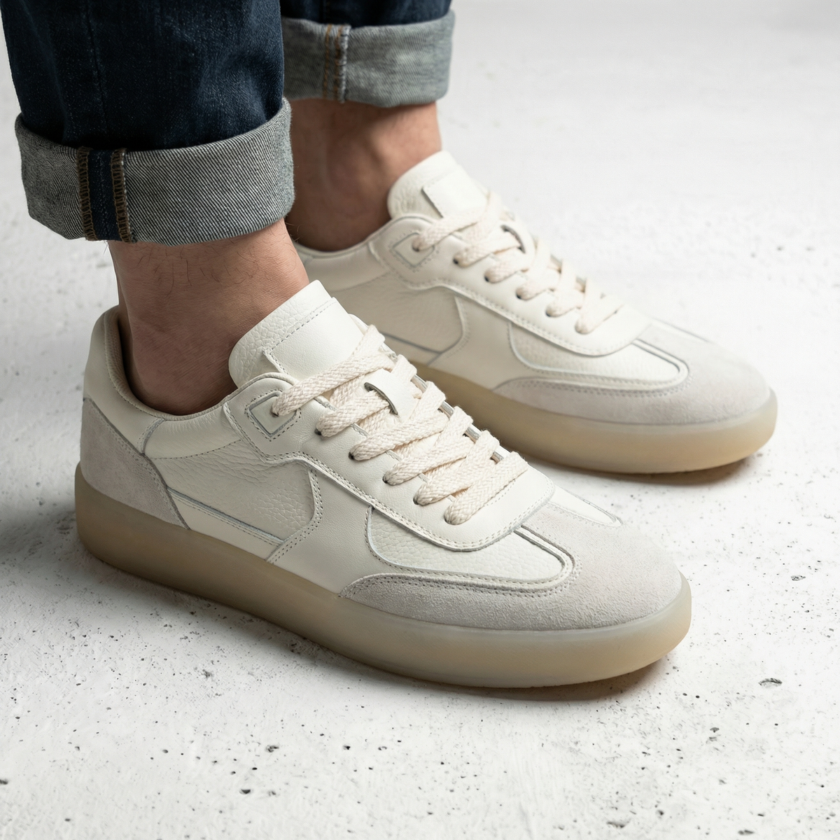 Beige men's lace-up sneakers with textured panels and gum-coloured soles