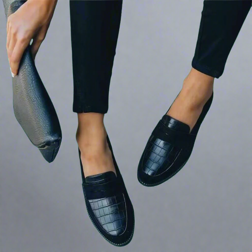 Black women's loafers with textured front panels and flat heels