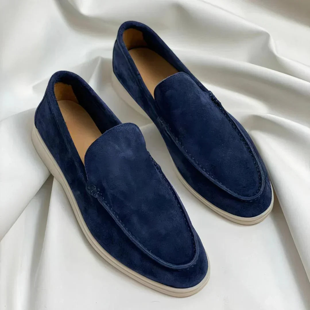 Men's slip-on loafers with rounded toes, stitched apron detailing and flat light-coloured soles