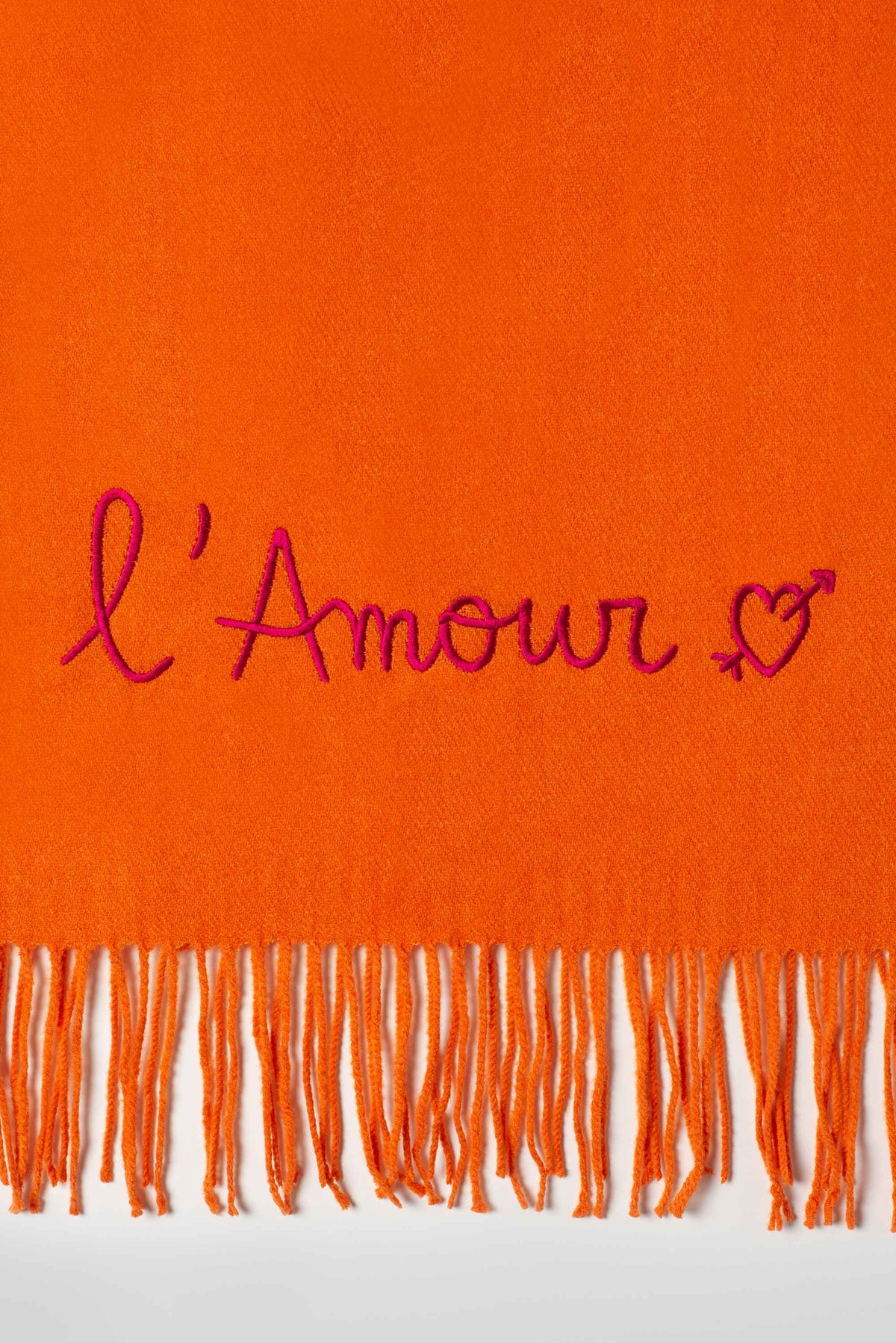 Rectangular fringed scarf with embroidered love message and heart motif