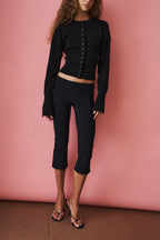 Women's black cropped cardigan with round neck, long sleeves and front buttons