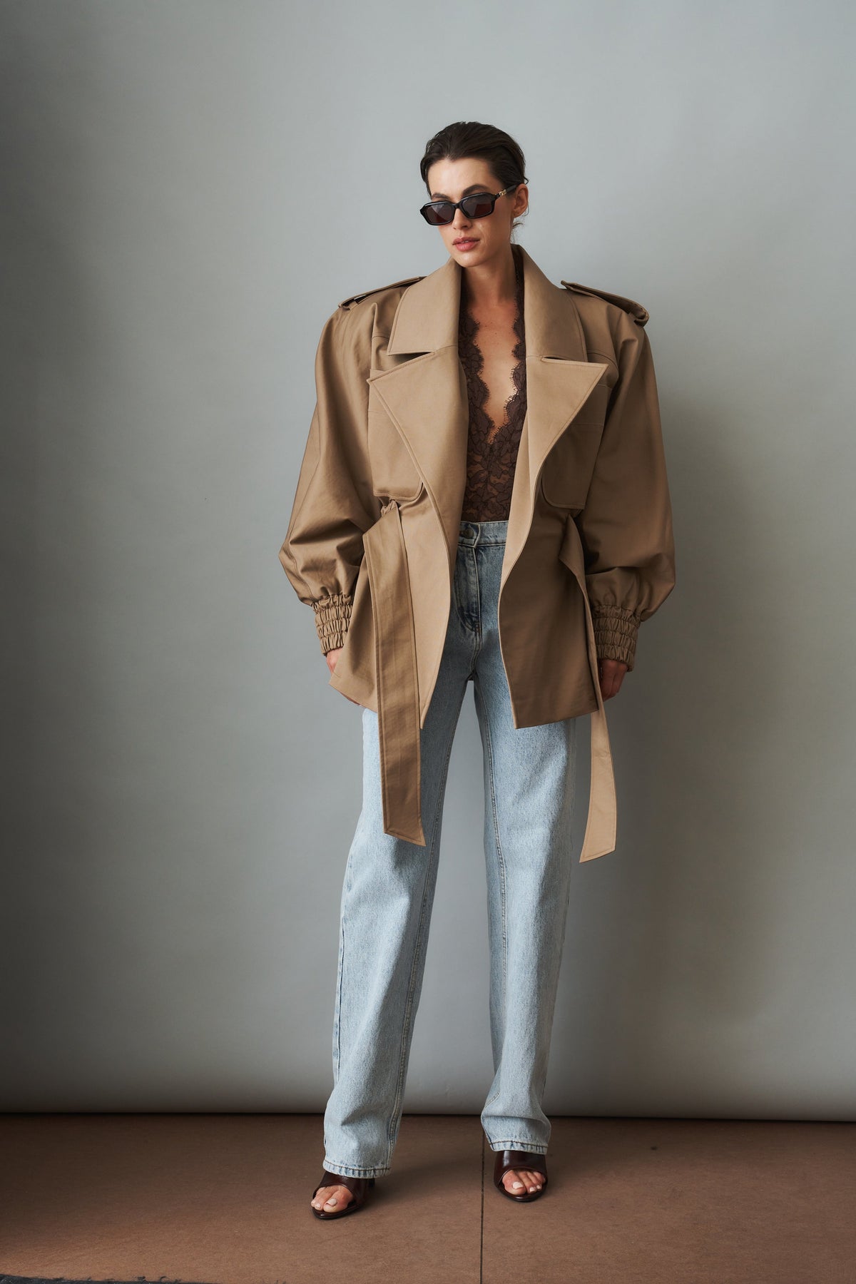 Women's beige tie-waist trench coat with wide lapels and gathered long sleeves