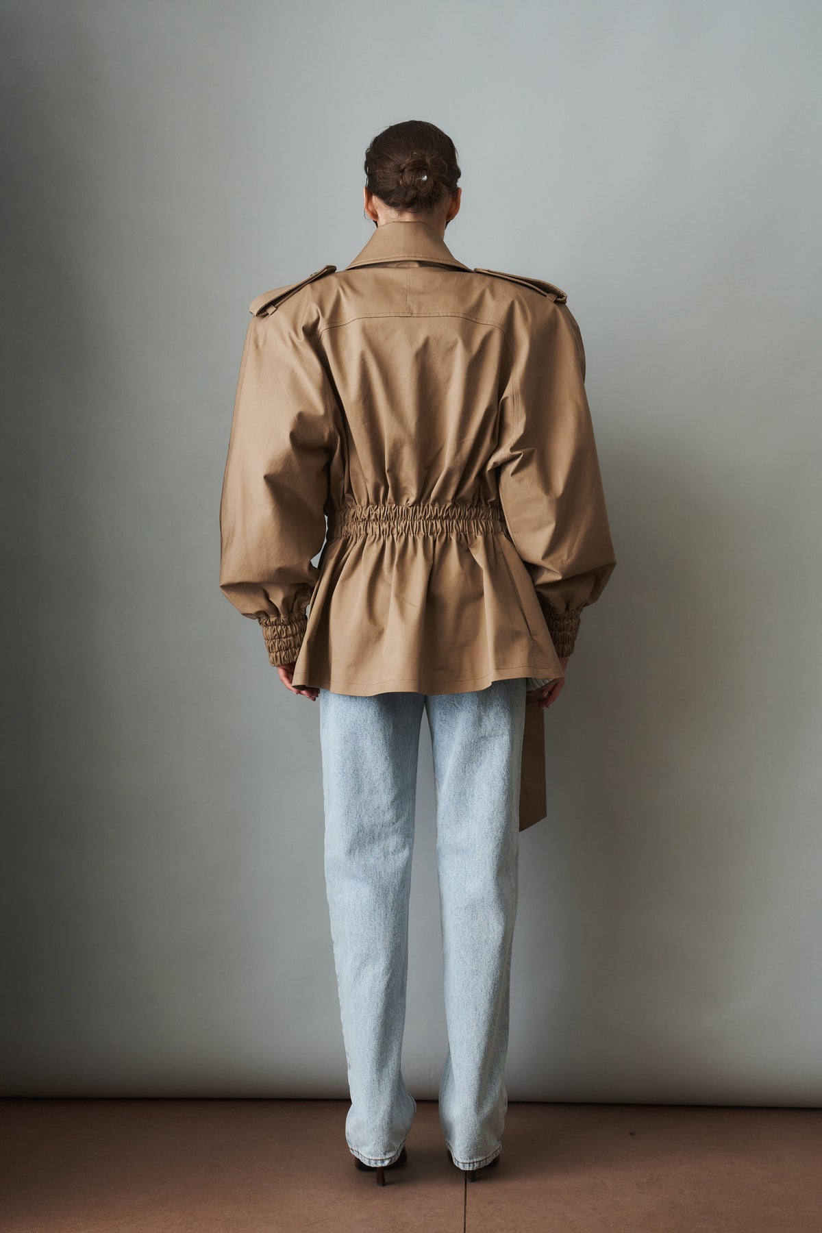 Women's beige tie-waist trench coat with wide lapels and gathered long sleeves