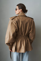Women's beige tie-waist trench coat with wide lapels and gathered long sleeves