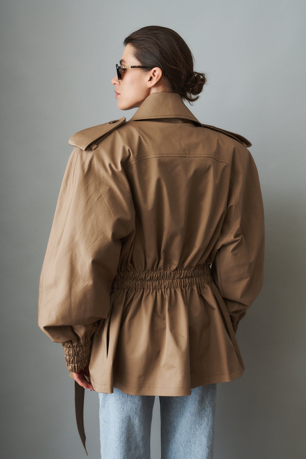 Women's beige tie-waist trench coat with wide lapels and gathered long sleeves