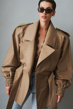 Women's beige tie-waist trench coat with wide lapels and gathered long sleeves