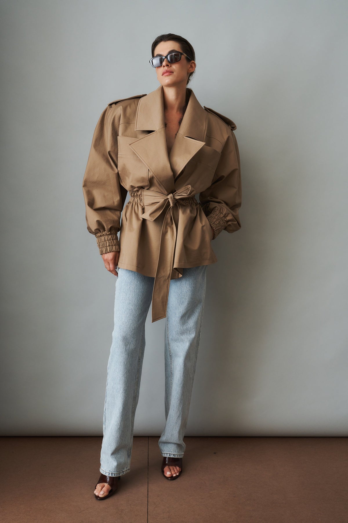 Women's beige tie-waist trench coat with wide lapels and gathered long sleeves