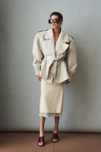 Women's cream trench coat with wide lapels, tie waist and elasticated cuffs