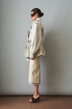 Women's cream trench coat with wide lapels, tie waist and elasticated cuffs