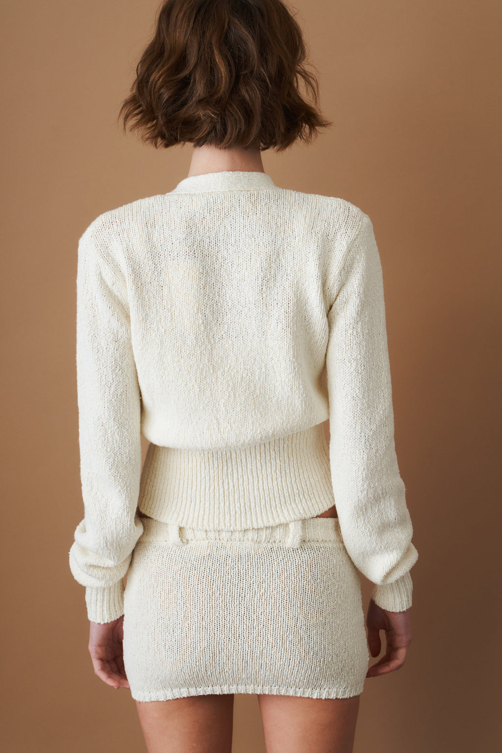 Women's cream cropped V-neck cardigan with long sleeves and button front