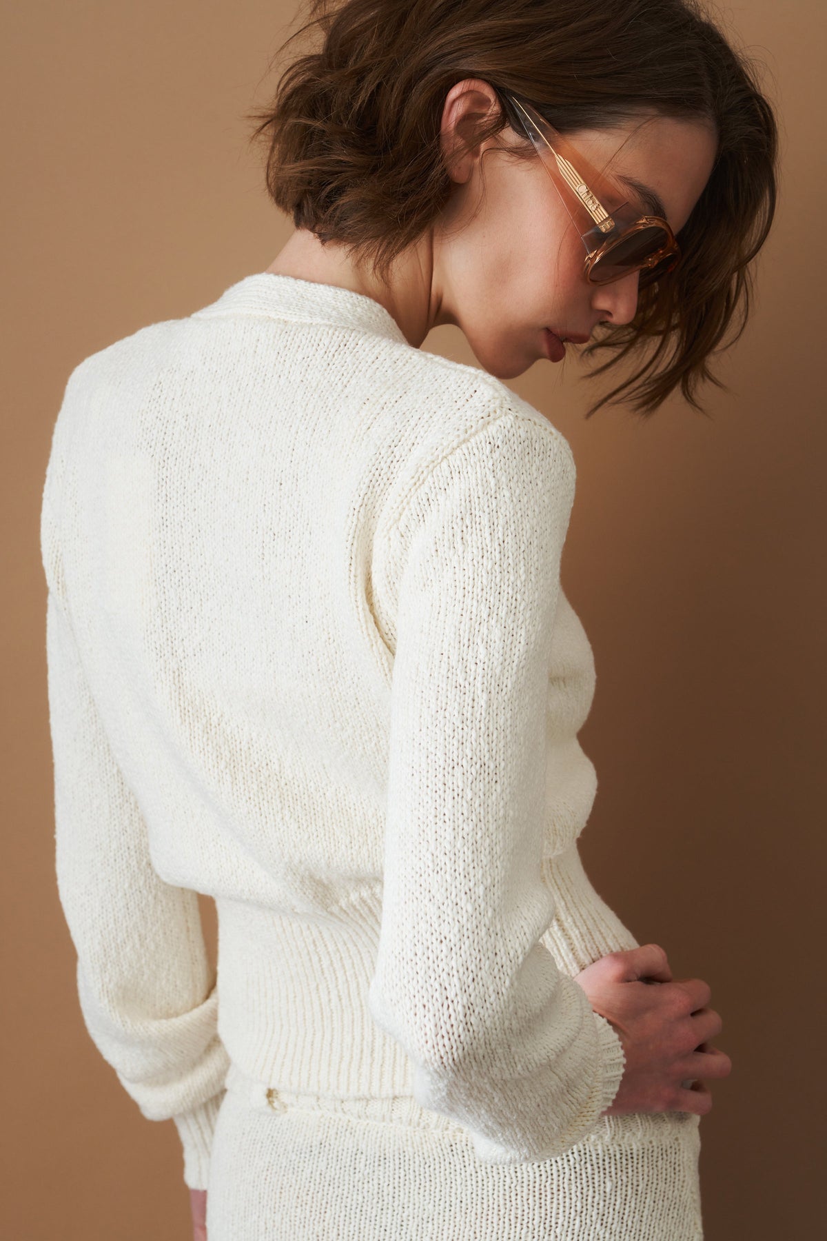 Women's cream cropped V-neck cardigan with long sleeves and button front