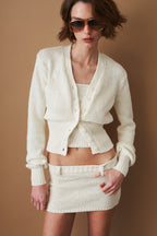 Women's cream cropped V-neck cardigan with long sleeves and button front