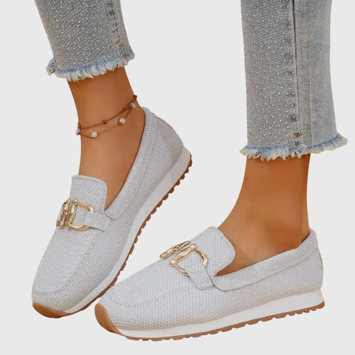 Women's textured loafers with rounded toes and front buckle details