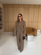 Women's taupe tailored blazer with notch lapels, long sleeves and flap pockets