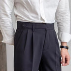 Women's high-waisted pleated straight-leg trousers with belt loops and long hems