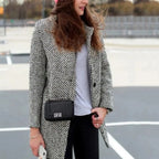 Women's long black and white herringbone coat with notched collar and button fastening