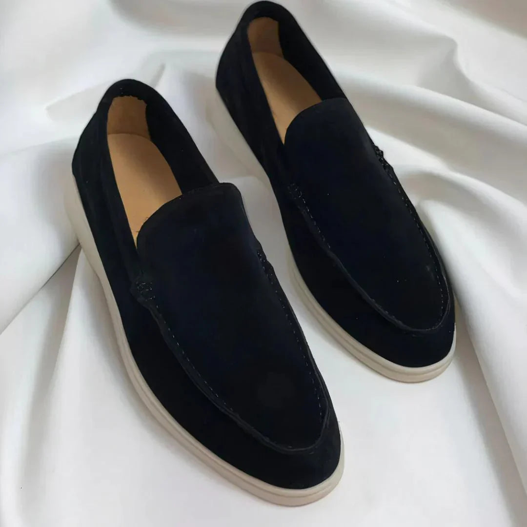 Men's slip-on loafers with rounded toes, stitched apron detailing and flat light-coloured soles