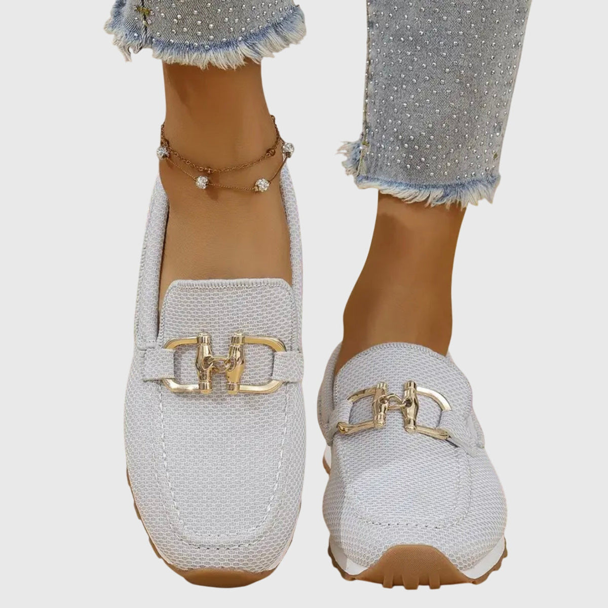 Women's textured loafers with rounded toes and front buckle details
