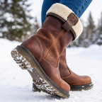 Brown ankle boots with cream fur-style cuffs, buckle trim and lugged soles
