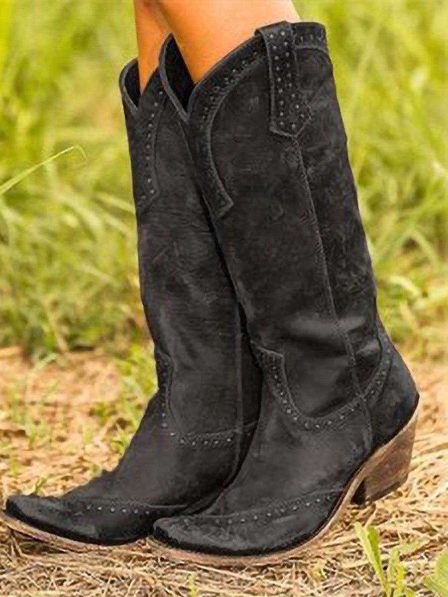 Tall studded Western cowboy boots with pointed toes and low heels