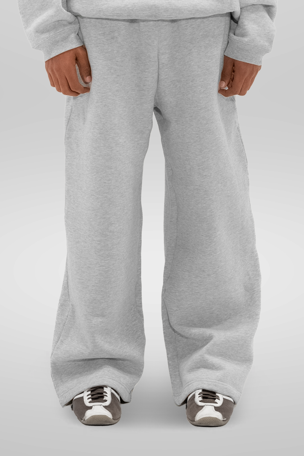 Men's grey wide-leg fleece sweatpants shown with trainers